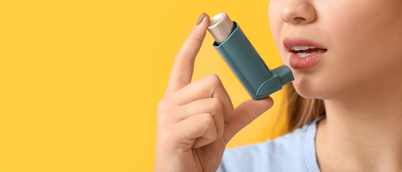 Young woman with inhaler.