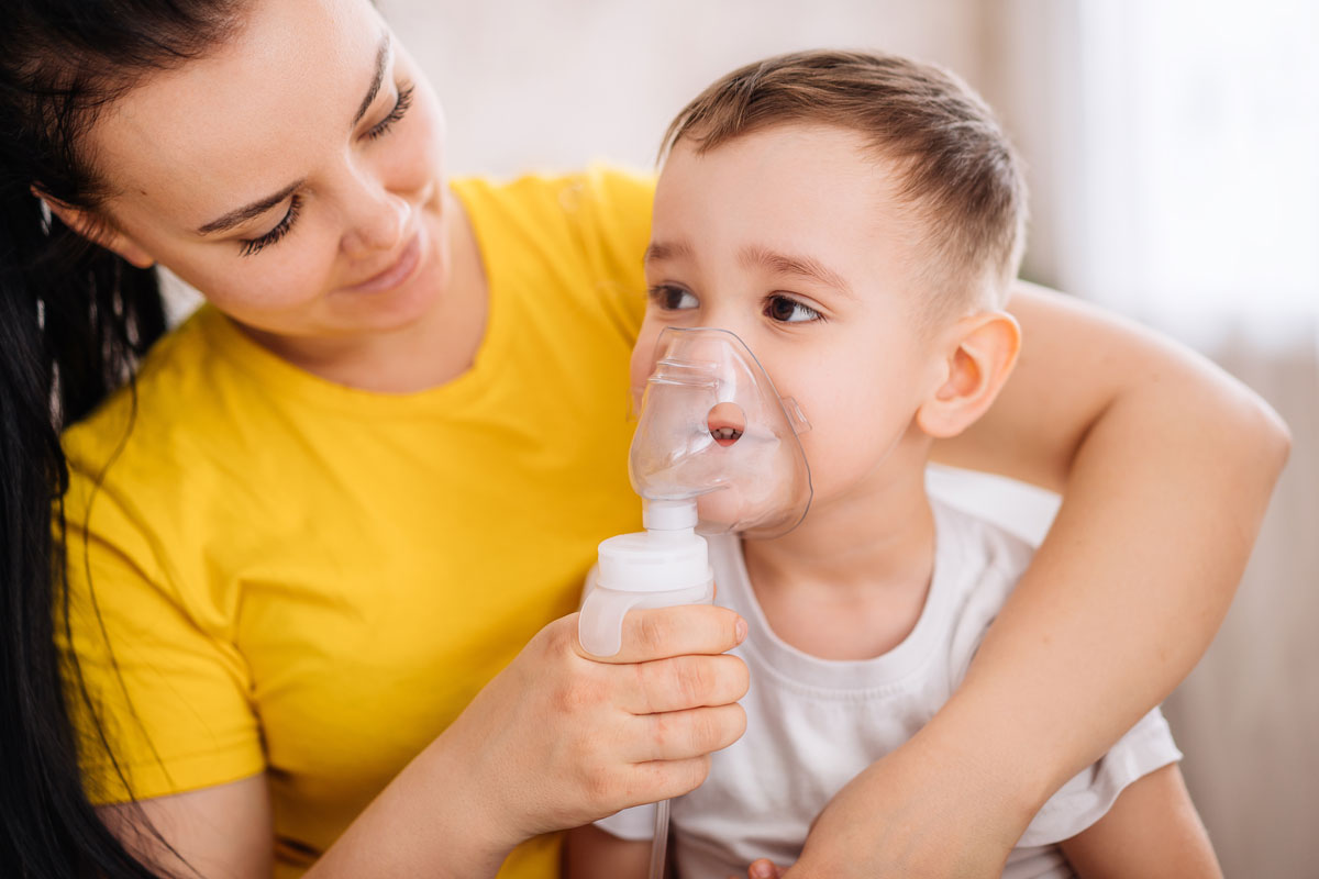 Mother administering a child with a Nebulizer